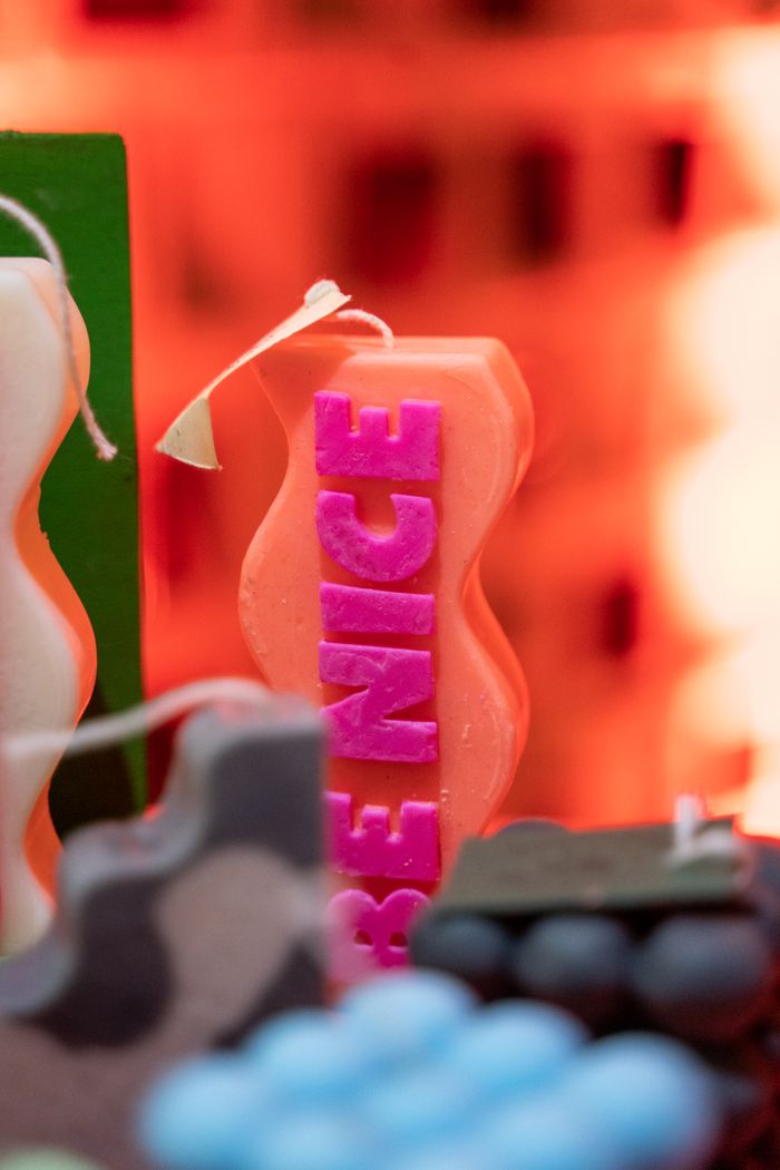 about-img A close-up of vibrant candles with 'Be Nice' text, creating a warm and inviting ambiance.