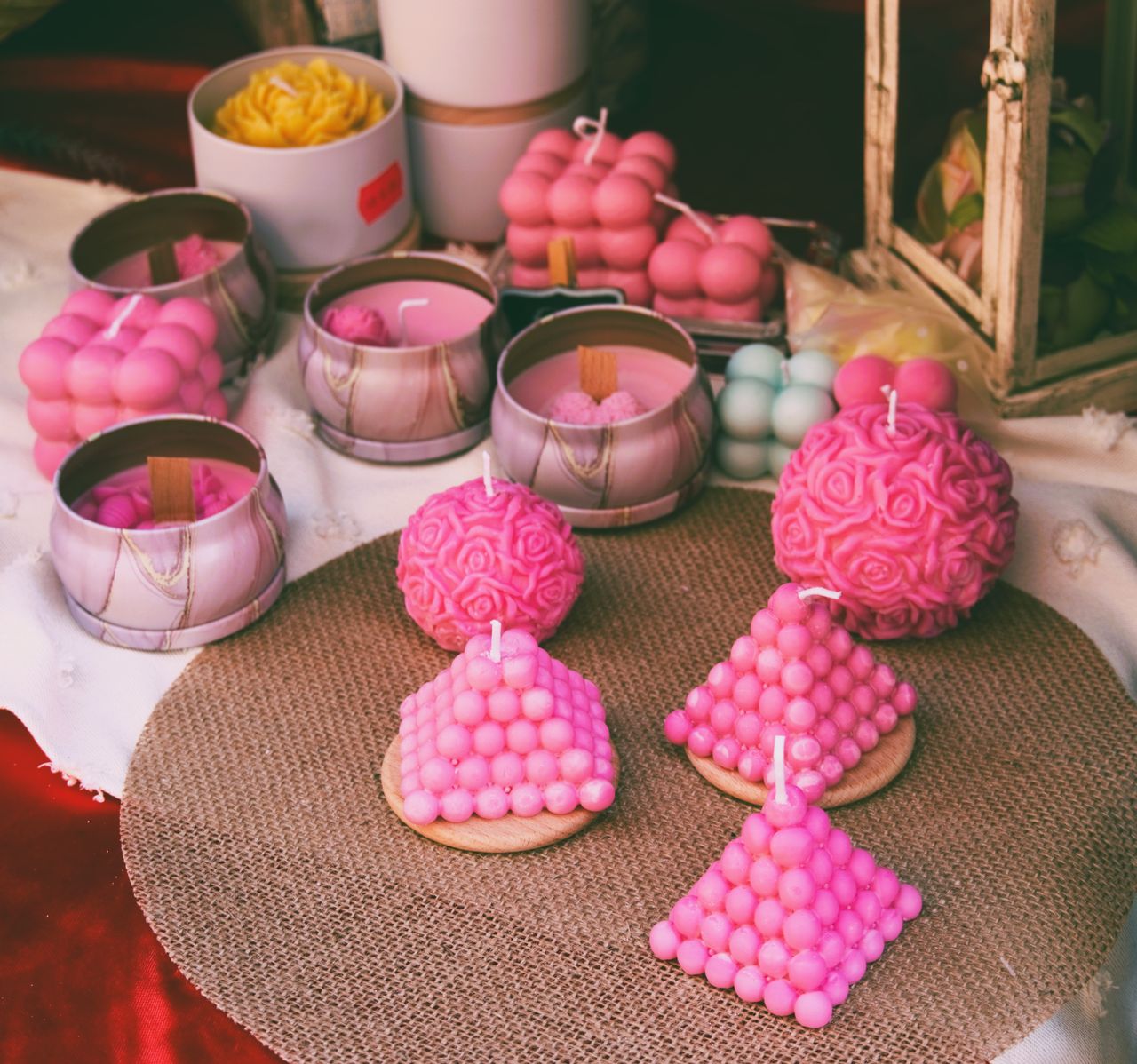 ours-journey A selection of vibrant pink handmade candles in various shapes, perfect for home decor.