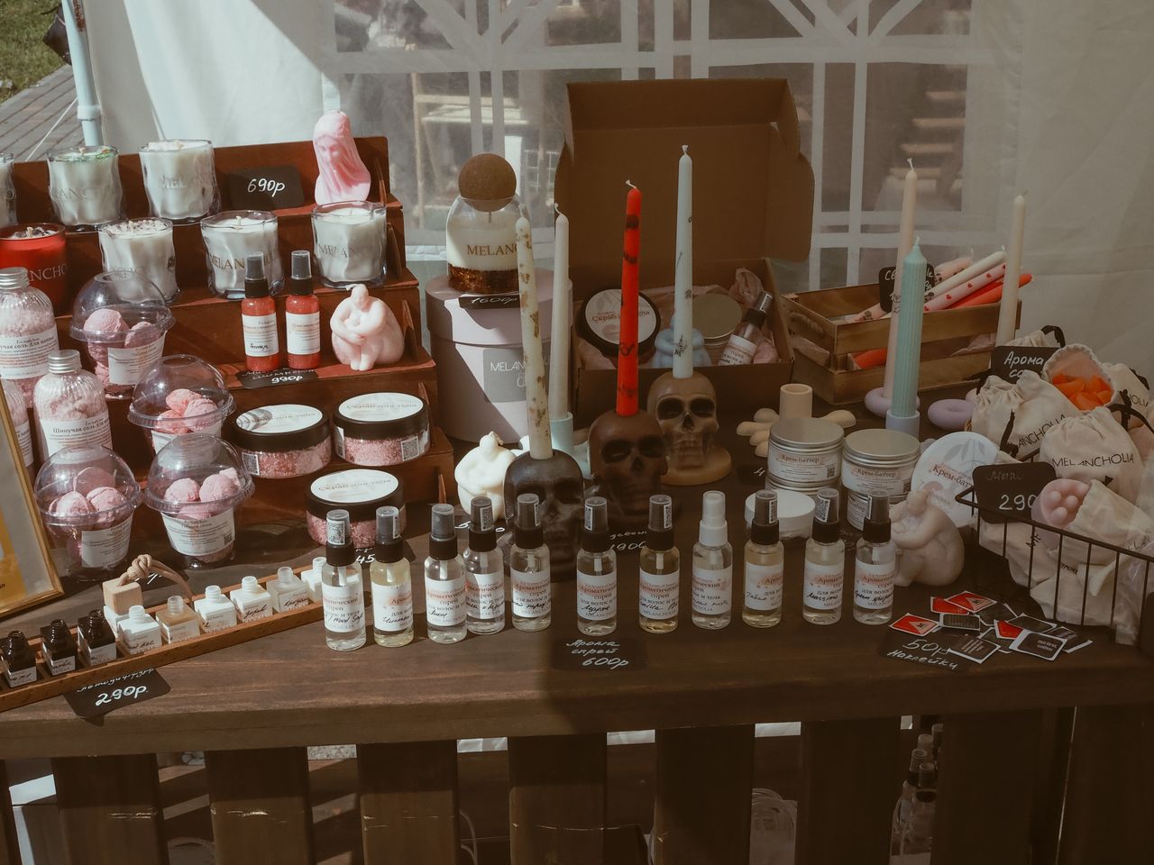 gallery-4 Display of handcrafted candles, skincare items, and decorative pieces at a market stall.