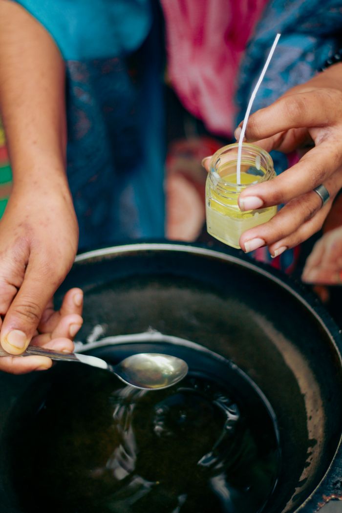 gallery-6 Hands making eco-friendly candles in Dhaka, showcasing sustainable crafting techniques.